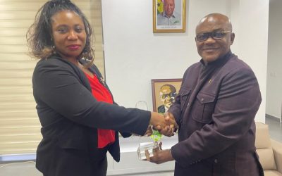 THE HUMAN RESOURCE MANAGER, LOUISA DADZIE HANDING OVER THE AWARD TO THE CHIEF EXECUTIVE OF FWSC, DR GEORGE SMITH -GRAHAM